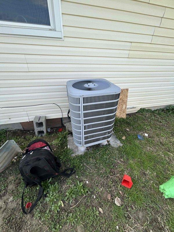 # Service Report: No Cooling - Central Air System

## Summary
Responded to no cooling complaint on 10-15 year old central air conditioning system with reported intermittent heating issues. Performed diagnostic evaluation of outdoor condensing unit and measured refrigerant pressures and temperatures using digital manifold gauges.

## Work Performed

Arrived on-site within scheduled appointment window to address air conditioning system not activating. Customer reported AC not kicking on and previous intermittent heating performance concerns on central air system.

Conducted visual inspection of outdoor condensing unit positioned on concrete pad at side of residence. Unit appeared to be in serviceable condition with standard cylindrical configuration and perimeter metal grille. Accessed service ports on condensing unit to perform refrigerant system diagnostics.

Connected Fieldpiece SMAN digital refrigerant manifold with three-hose setup (standard yellow, blue, and red service hoses) to u