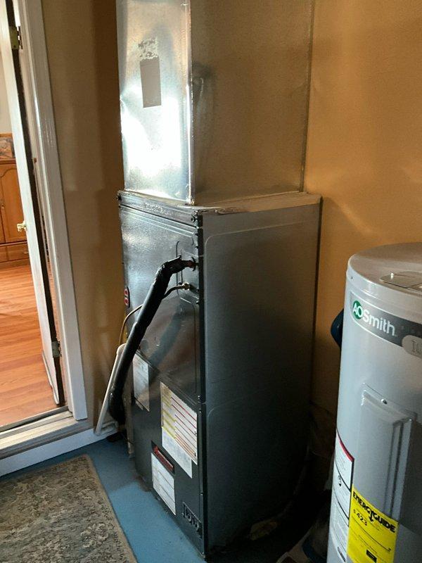 # HVAC System Replacement Summary

Responded to service call for non-operational air conditioning system with complete refrigerant loss. Upon inspection, determined outdoor condensing unit and indoor air handler required full system replacement due to age and condition. Removed existing HVAC equipment including outdoor condenser unit positioned on concrete pad against exterior wall and indoor furnace/air handler located in utility closet adjacent to water heater. Installed new complete HVAC system with appropriately sized equipment for residential application. Completed refrigerant line connections, electrical hookups, and ductwork integration to existing infrastructure. System tested and verified operational upon completion.