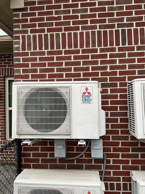 # HVAC Estimate - Replacement Summary

Conducted comfort consultation for full system replacement estimate due to outdoor coil leak on existing unit with unavailable replacement parts. Evaluated current multi-zone Mitsubishi Electric ductless mini-split system installation with multiple outdoor condensers mounted on exterior brick wall. Documented existing equipment configuration and discussed replacement options with customer to address failed component and restore climate control functionality on expedited timeline per customer request.