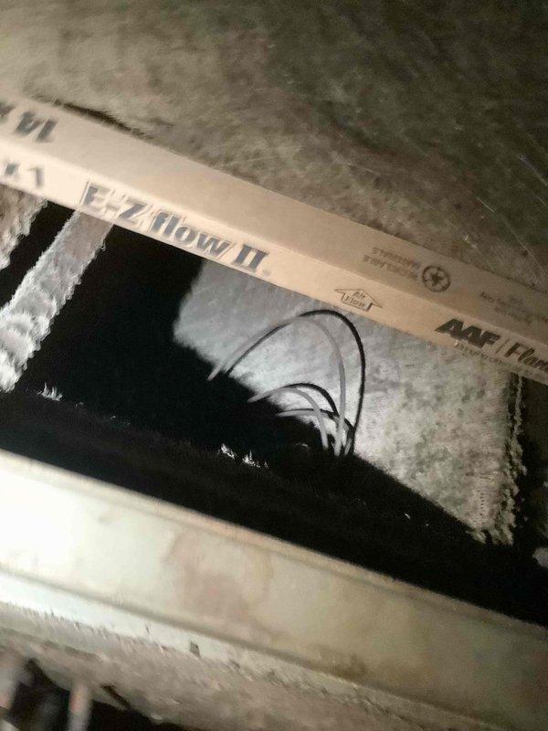 Responded to no heating and no cooling complaint at commercial facility. Upon inspection, discovered evaporator coil completely frozen with heavy frost and ice buildup throughout the heat exchanger assembly. Identified dirty and clogged air filter restricting airflow to the system, which contributed to the freeze condition. Documented filter condition showing significant dust accumulation and discoloration. System requires filter replacement and proper defrost cycle before resuming normal operation to restore heating and cooling functionality.