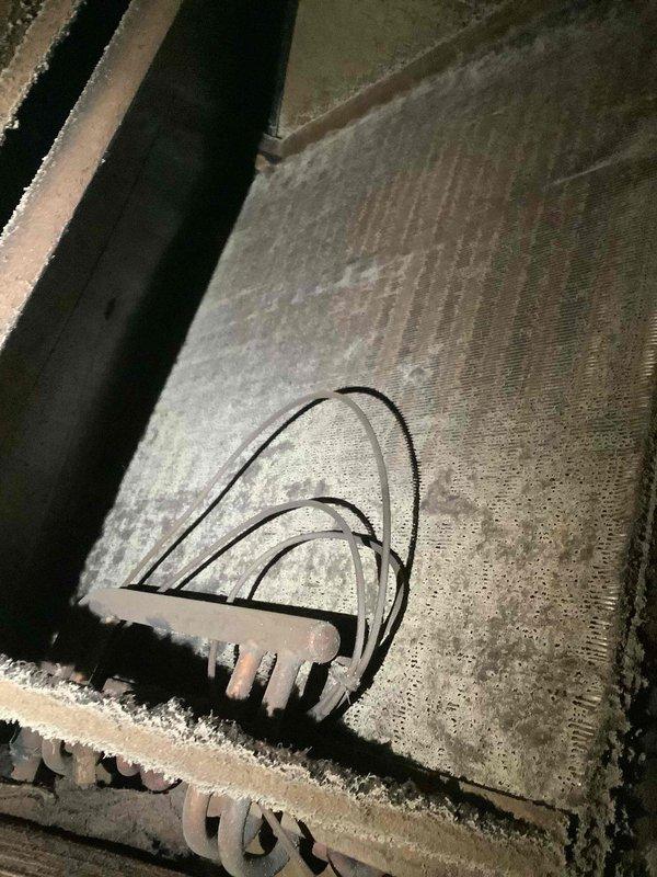 Responded to no heating and no cooling complaint at commercial facility. Upon inspection, discovered evaporator coil completely frozen with heavy frost and ice buildup throughout the heat exchanger assembly. Identified dirty and clogged air filter restricting airflow to the system, which contributed to the freeze condition. Documented filter condition showing significant dust accumulation and discoloration. System requires filter replacement and proper defrost cycle before resuming normal operation to restore heating and cooling functionality.