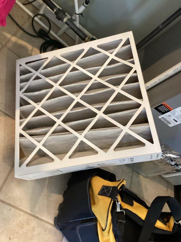 Completed basic monthly HVAC maintenance including system inspection and filter evaluation. Inspected electrical components including capacitor and wiring connections within the unit's control panel, verified proper mounting and connections. Assessed 20x20x4 air filter condition, noting pleated media appeared relatively clean with uniform gray coloring across all sections.