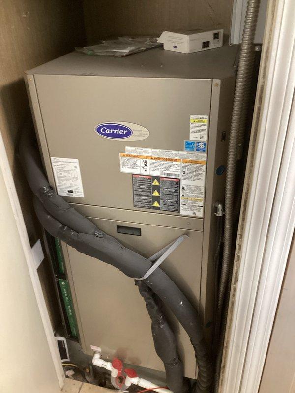 Responded to freeze sensor lockout fault on Carrier geothermal heat pump air handler. Upon arrival, system was operational with no active heating or cooling issues, but displayed flashing fault code. Accessed thermostat geo HP settings and reviewed freeze limit parameters, lockout count settings, and brownout override configuration. Verified freeze sensor thresholds set at 26°F and 15°F with lockout counts of 4 and 2 respectively. Cleared freeze sensor lockout fault from system memory and confirmed normal operation resumed without further error codes.