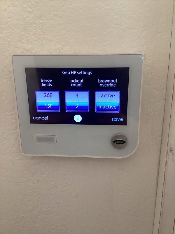 Responded to freeze sensor lockout fault on Carrier geothermal heat pump air handler. Upon arrival, system was operational with no active heating or cooling issues, but displayed flashing fault code. Accessed thermostat geo HP settings and reviewed freeze limit parameters, lockout count settings, and brownout override configuration. Verified freeze sensor thresholds set at 26°F and 15°F with lockout counts of 4 and 2 respectively. Cleared freeze sensor lockout fault from system memory and confirmed normal operation resumed without further error codes.