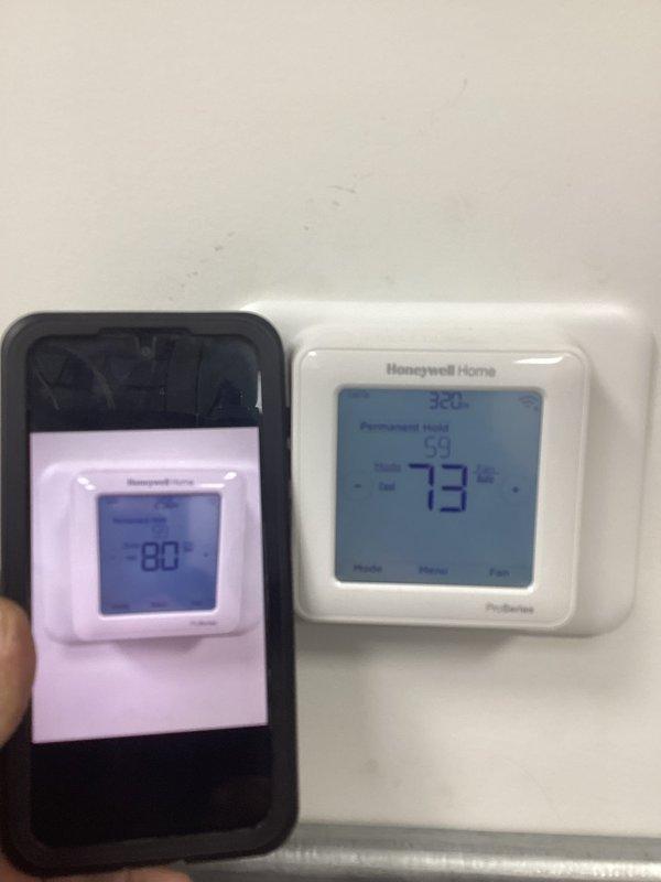 Responded to diagnostic service call for conventional HVAC system with ceiling-mounted equipment. Upon arrival, evaluated Honeywell Home ProSeries thermostat displaying 73°F with permanent hold setting active. Documented thermostat operation and display readings for diagnostic purposes to determine system performance issues.