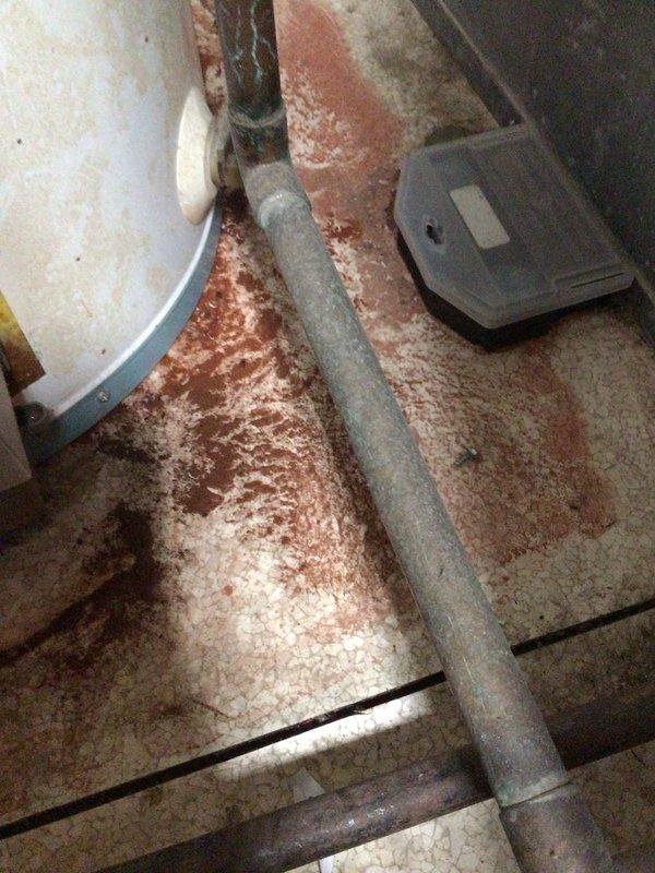 Responded to service call for reported water heater failure. Upon inspection, confirmed tanked water heater was cracked and actively leaking, resulting in water damage and accumulation of debris on surrounding floor area. Documented extensive interior deterioration including compromised tank integrity, aged insulation with visible staining and discoloration, and sediment buildup at base of unit. Photographed damaged components including cracked tank shell, central flue pipe, burner assembly, and deteriorated internal insulation material. Contacted dispatch with repair options and recommendations for unit replacement due to catastrophic tank failure.