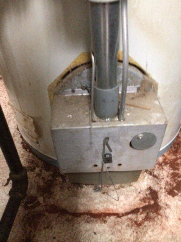 Responded to service call for reported water heater failure. Upon inspection, confirmed tanked water heater was cracked and actively leaking, resulting in water damage and accumulation of debris on surrounding floor area. Documented extensive interior deterioration including compromised tank integrity, aged insulation with visible staining and discoloration, and sediment buildup at base of unit. Photographed damaged components including cracked tank shell, central flue pipe, burner assembly, and deteriorated internal insulation material. Contacted dispatch with repair options and recommendations for unit replacement due to catastrophic tank failure.