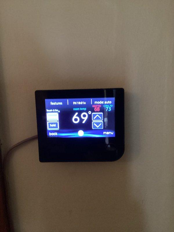 Completed routine heating maintenance and tune-up service on two HVAC systems as requested. Performed comprehensive inspection of blower motor assembly, verifying proper operation of centrifugal fan and motor shaft components. Checked thermostat functionality, confirmed system operating in auto mode with cooling setpoint at 63°F and heating setpoint at 75°F, with current room temperature reading 69°F. All components found operating within normal parameters and both units ready for heating season.