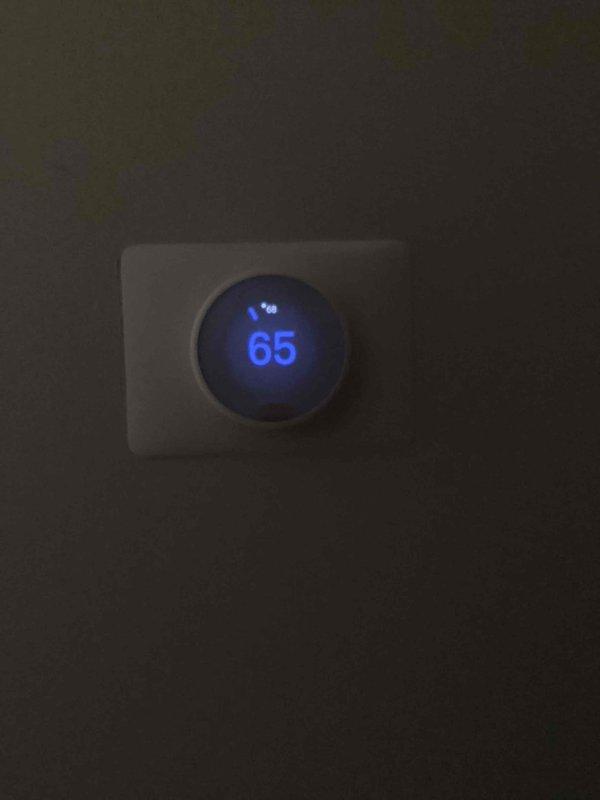 Responded to no cooling complaint on residential air conditioning system. Upon arrival, confirmed unit was running but not producing cold air. Evaluated outdoor condenser unit and indoor thermostat settings, documented system conditions with photos showing condenser positioned on exterior concrete pad and thermostat display reading 65°F. Customer requested callback with repair options and payment arrangements prior to technician departure.