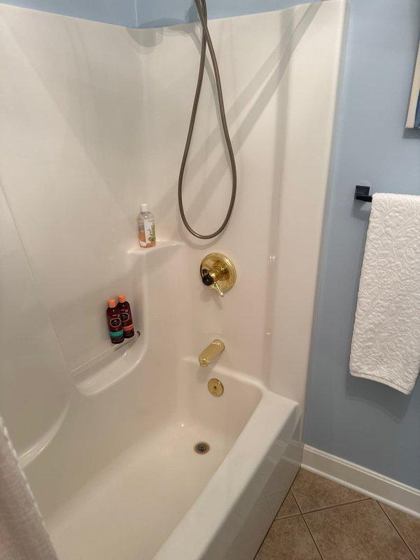 Responded to main level guest bathroom for non-functioning bathtub drain stopper. Upon inspection, confirmed existing brass-finished trip lever drain assembly was failing to hold water, allowing continuous drainage. Provided estimate for replacement of complete bathtub drain and overflow assembly with matching brass finish to coordinate with existing tub spout and fixtures.