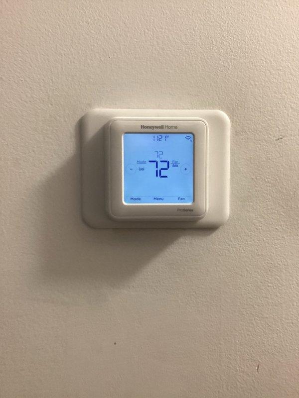Returned to property to replace defective Honeywell Home T6 digital thermostat under warranty. Removed failed unit from wall and installed new replacement thermostat, connecting all necessary wiring and verifying proper communication with HVAC system. Confirmed unit powered on correctly, programmed settings, and tested cooling operation to ensure system responded appropriately to thermostat commands.