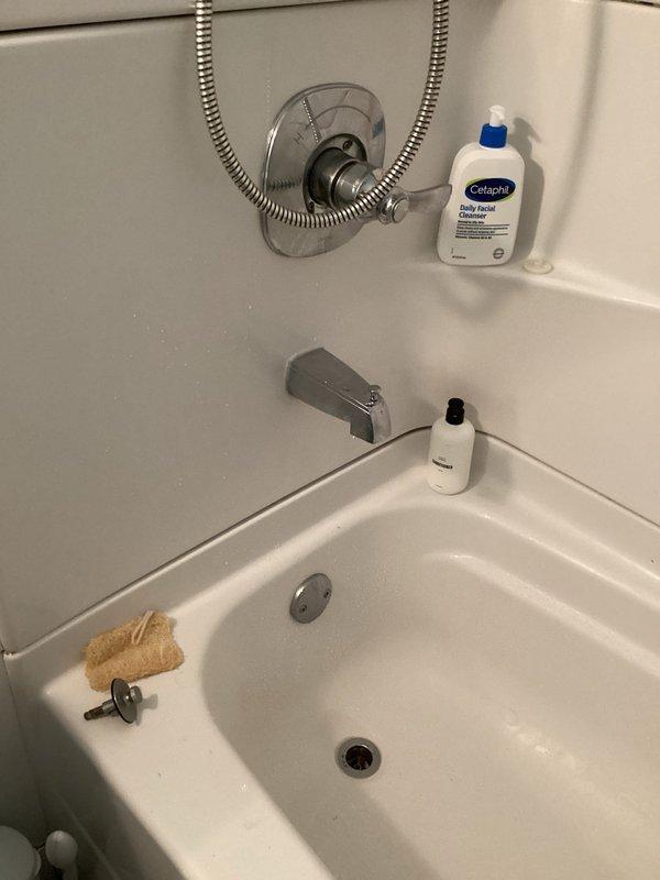 Responded to water leak complaint affecting basement area during shower operation. Inspected tub/shower assembly and identified leak source at shower valve trim and handle set rather than tub drain as initially suspected. Tightened valve stem packing nuts, replaced worn valve cartridge seals, and resealed escutcheon plate against wall surface to eliminate water intrusion. Tested system by running shower at full pressure to verify leak was resolved and no water penetration occurred into basement below.