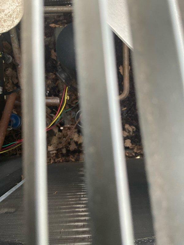 Responded to service call for 9-year-old HVAC system that experienced electrical damage from repeated power surges during utility pole replacement work. Conducted thorough inspection of outdoor condenser unit, documenting significant debris accumulation within cabinet and assessing electrical components including control board, capacitor, and wiring. Provided comprehensive replacement estimate after determining multiple components likely sustained damage from power fluctuations, recommending full system replacement versus individual component repairs given age of equipment and extent of potential electrical damage.