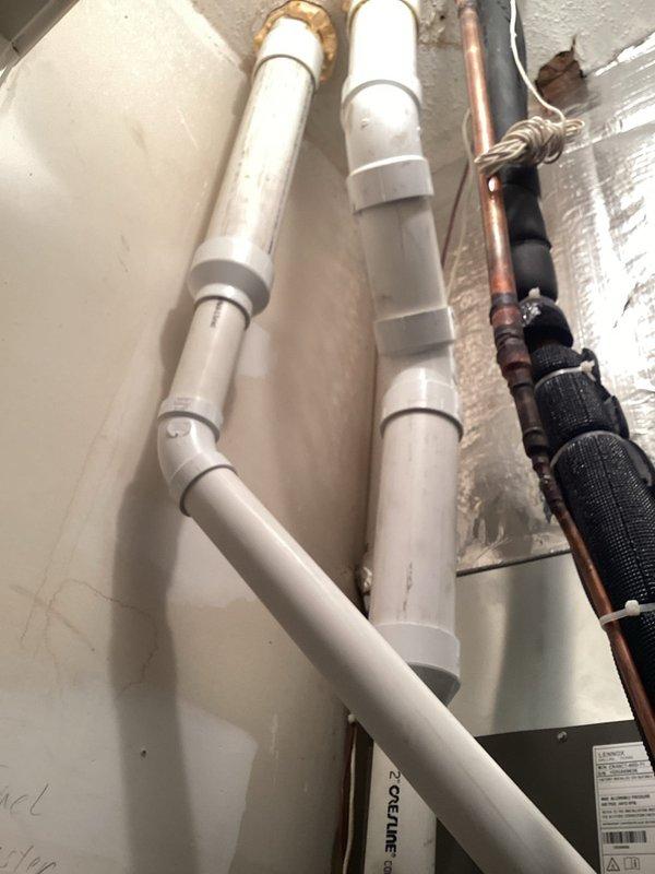 Responded to warranty call for leaking vent line with visible water damage on floor. Upon inspection, identified leak at PVC pipe joint connection in the condensate drain system. Disassembled affected joint, cleaned and prepped surfaces, and reassembled connection with proper primer and cement application to ensure watertight seal. Verified all adjacent PVC connections for integrity and proper support. Tested system operation and confirmed no further leakage present. Documented installation with photos showing pipe routing, connections, and surrounding HVAC components including refrigerant lines and drainage system.