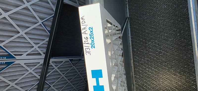 Performed heating maintenance on two HVAC units at the facility. Documented filter requirements for both systems: each unit contains two filter racks with the top rack requiring three 20x24x2 filters and the bottom rack requiring three 20x25x2 filters. Total filter specifications needed for ongoing maintenance are six 20x24x2 filters and six 20x25x2 filters. Inspected internal components including blower motor assembly, electrical connections, and control board. Photographed filter configuration and internal unit components for service records.