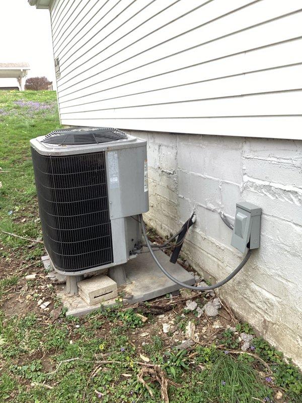 Responded to no cooling complaint with unit running but delivering warm air. Upon inspection, found failed dual-run capacitor with bulging and visible deterioration. Tested capacitor readings showing significant deviation from rated 35/5 microfarad specification at 370VAC. Replaced defective capacitor with new OEM equivalent, reconnected all electrical terminals to contactor and compressor/fan motor circuits, and verified proper wire routing. Started system and confirmed compressor and condenser fan motor operation with normal amp draw. Tested supply air temperature showing proper cooling differential. System restored to normal operation with adequate cooling capacity.