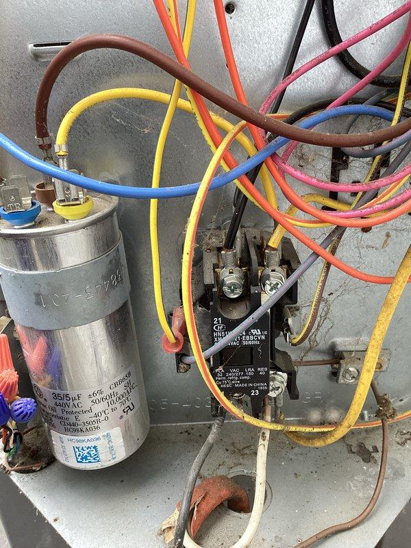 Responded to no cooling complaint with unit running but delivering warm air. Upon inspection, found failed dual-run capacitor with bulging and visible deterioration. Tested capacitor readings showing significant deviation from rated 35/5 microfarad specification at 370VAC. Replaced defective capacitor with new OEM equivalent, reconnected all electrical terminals to contactor and compressor/fan motor circuits, and verified proper wire routing. Started system and confirmed compressor and condenser fan motor operation with normal amp draw. Tested supply air temperature showing proper cooling differential. System restored to normal operation with adequate cooling capacity.