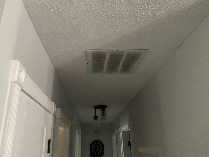 Completed estimate for residential duct cleaning system. Inspected multiple supply and return vents throughout the home, including floor registers in carpeted areas and ceiling-mounted vents in hallway. Assessed condition of ductwork and noted accumulation of dust and debris within visible vent openings. Investigated dryer vent routing concern and attempted to trace exhaust path to determine if termination point is properly vented to exterior or potentially misdirected beneath structure. Documented current HVAC system layout and vent locations with photographs for estimate preparation.