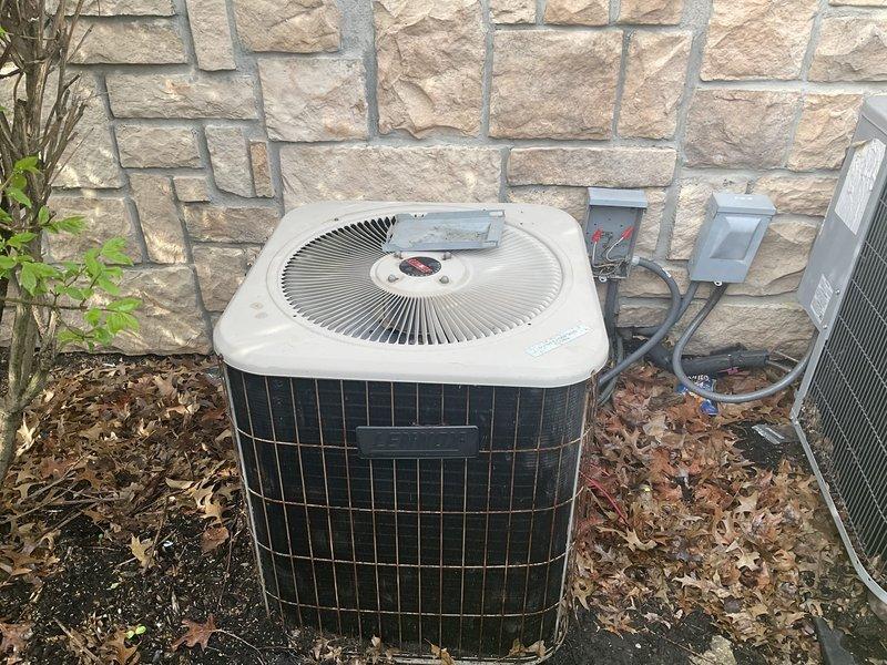 Completed full heat pump system replacement including outdoor condensing unit and indoor air handler. Installed new Lennox Elite Series air handler with proper PVC condensate drainage and refrigerant line connections. Mounted outdoor heat pump unit on ground-level pad against exterior stone wall with new electrical disconnect box and proper conduit wiring. Verified all refrigerant lines, electrical connections, and drainage systems functioning correctly upon startup.