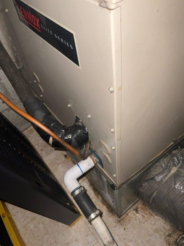 Completed full heat pump system replacement including outdoor condensing unit and indoor air handler. Installed new Lennox Elite Series air handler with proper PVC condensate drainage and refrigerant line connections. Mounted outdoor heat pump unit on ground-level pad against exterior stone wall with new electrical disconnect box and proper conduit wiring. Verified all refrigerant lines, electrical connections, and drainage systems functioning correctly upon startup.