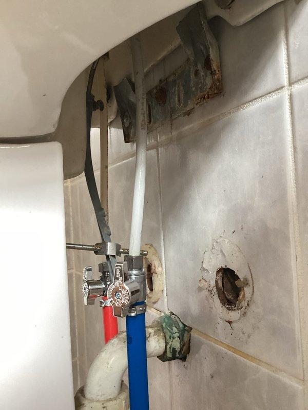 Returned to address issues from recent waterline replacement work. Reconnected kitchen sink drain assembly that had been left disconnected during previous installation, which was causing water to discharge directly onto the floor. Repaired leaking connection at downstairs bathroom where new waterline from basement penetrated through to fixture. Verified all connections were secure and tested system for proper drainage and water supply operation with no further leaks detected.