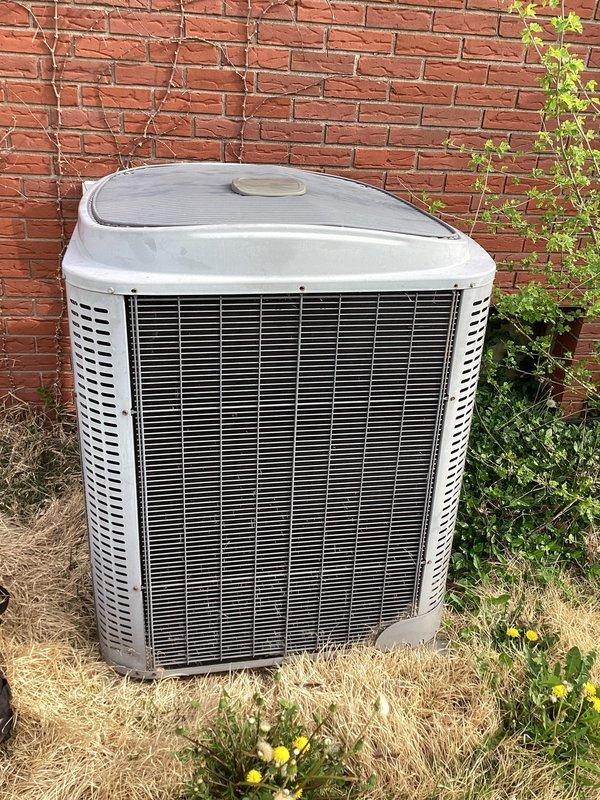 Responded to no cooling call for residential air conditioning system over 10 years old. Upon arrival, found outdoor condenser unit installed on ground level against brick exterior wall. Performed system diagnostics and temperature differential testing at thermostat, which displayed current temperature of 75°F with setpoint at 70°F, indicating unit was not maintaining desired cooling temperature. Conducted comprehensive inspection of condenser unit including visual assessment of compressor operation, refrigerant levels, and electrical components. Evaluated airflow through louvers and checked for proper condenser fan operation. System restored to normal cooling operation following service procedures.