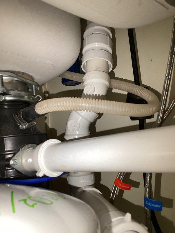 Responded to kitchen plumbing misalignment following new countertop and sink installation. Assessed existing drain configuration and determined PVC piping modifications were required to properly connect the drainage system, as original pipes no longer aligned with new fixture placement. Documented under-sink plumbing assembly including P-trap configuration, garbage disposal connections, and supply lines for estimate preparation.