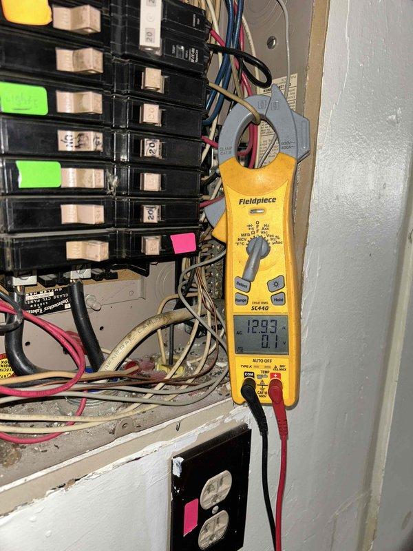 Responded to service call for HVAC system reporting pressure issues. Upon arrival, performed initial visual inspection of electrical service panel and documented existing breaker configuration with multiple circuits labeled and color-coded, including a 40-amp breaker and one marked as overloaded. Utilized clamp meter to take amperage readings at the panel, recording 129.9 amps on primary circuit to assess electrical load and system draw. Unable to complete full system diagnostics due to inclement weather conditions preventing safe outdoor unit access and refrigerant pressure testing. Documented panel condition showing recent insulation work with expanding foam sealant around enclosure. System requires follow-up visit under warranty to perform complete pressure diagnostics on both high and low side refrigerant circuits once weather permits safe access to outdoor equipment.