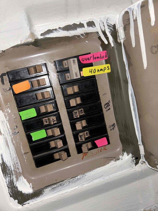 Responded to service call for HVAC system reporting pressure issues. Upon arrival, performed initial visual inspection of electrical service panel and documented existing breaker configuration with multiple circuits labeled and color-coded, including a 40-amp breaker and one marked as overloaded. Utilized clamp meter to take amperage readings at the panel, recording 129.9 amps on primary circuit to assess electrical load and system draw. Unable to complete full system diagnostics due to inclement weather conditions preventing safe outdoor unit access and refrigerant pressure testing. Documented panel condition showing recent insulation work with expanding foam sealant around enclosure. System requires follow-up visit under warranty to perform complete pressure diagnostics on both high and low side refrigerant circuits once weather permits safe access to outdoor equipment.