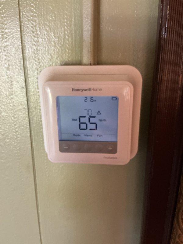 Completed monthly CCH Basic maintenance service on residential heating system. Inspected HVAC equipment in mechanical space and verified thermostat operation showing system in heating mode at 65°F with setpoint of 70°F. Customer requires 20x25x4 filter replacement, which was not included in this service visit.