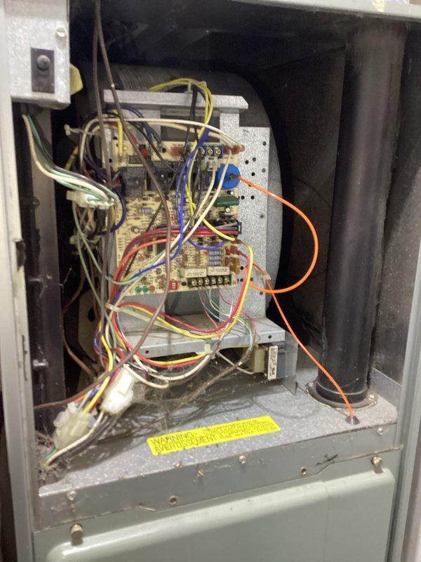 Responded to no cooling call and performed diagnostic inspection of residential HVAC system. Upon arrival, removed access panels and conducted thorough visual inspection of furnace cabinet interior, examining blower motor assembly, gas valve, burner components, and control board wiring. Inspected all electrical connections including low-voltage control wiring, terminal blocks, transformers, and relay assemblies for proper termination and signs of failure. Evaluated condition of blower motor, capacitor connections, and associated wiring harness. Assessed gas valve assembly and copper piping connections for integrity. Photographed control board configuration and internal components for documentation purposes. System showed typical operational wear with minor dust accumulation in cabinet but no immediate visible failures requiring emergency repair at time of inspection.