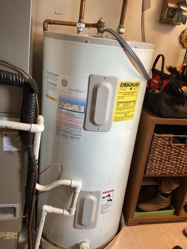Performed comprehensive assessment of existing GE SmartWater tank-style water heater for replacement evaluation. Inspected current installation including copper supply piping with visible corrosion and patina, pressure relief valve configuration, and electrical connections. Evaluated utility room space constraints and existing plumbing infrastructure to determine feasibility of tankless water heater conversion versus traditional tank replacement. Documented current water heater specifications, venting requirements, and adjacent water treatment equipment including water softener system. Provided customer with multiple replacement options comparing tankless and conventional tank systems, discussing installation requirements, space considerations, gas line capacity needs for tankless units, and electrical modifications that would be necessary for either option. Photographed existing installation conditions to support estimate preparation.
