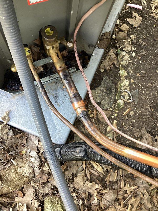 Returned to system to pressure test and verify leak location on outdoor suction line. Inspected outdoor unit and refrigerant line connections, confirming leak isolated to suction line under warranty coverage. Documented equipment condition and leak location with photos for warranty processing.
