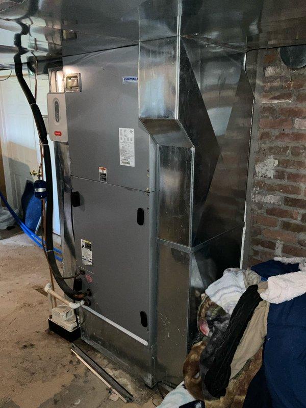 Conducted comfort consultation for full HVAC system replacement estimate. Inspection revealed both outdoor condenser coil and indoor evaporator coil actively leaking refrigerant due to system age. Documented existing equipment configuration including basement-mounted furnace with metal supply ductwork and outdoor condensing unit positioned against exterior brick wall. Provided comprehensive replacement options for complete system upgrade with priority timeline for immediate installation.