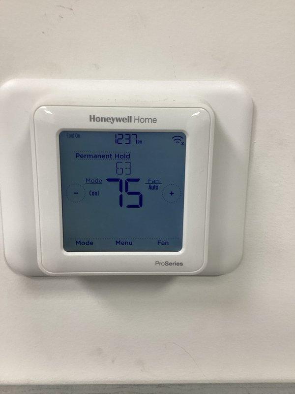 Returned to address previous frozen system condition. Upon arrival, verified thermostat operation and confirmed unit is now cycling properly in cooling mode with temperature reading 48°F and system responding to setpoint adjustments. System operating normally with no freeze-up present at time of inspection.