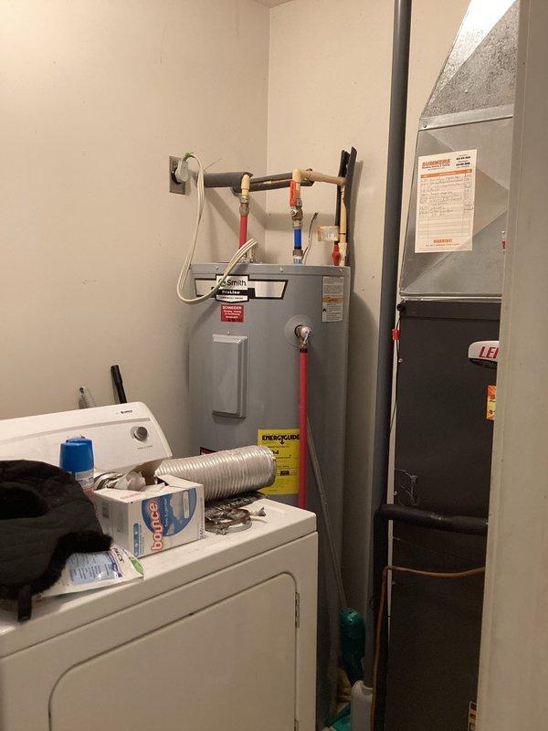 Completed comprehensive plumbing inspection of residential property as part of prepaid maintenance service. Inspected water heater installation in utility room, verifying proper connection of hot and cold water lines with brass fittings, confirming adequate clearances around unit, and checking for signs of leaks or corrosion. Examined bathroom shower fixtures including wall-mounted shower arm and chrome hardware, inspecting for proper installation, water flow, and potential leak points at wall penetrations. All plumbing systems found to be operating within normal parameters with no immediate repairs required at time of inspection.