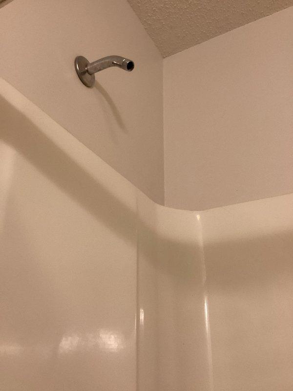 Completed comprehensive plumbing inspection of residential property as part of prepaid maintenance service. Inspected water heater installation in utility room, verifying proper connection of hot and cold water lines with brass fittings, confirming adequate clearances around unit, and checking for signs of leaks or corrosion. Examined bathroom shower fixtures including wall-mounted shower arm and chrome hardware, inspecting for proper installation, water flow, and potential leak points at wall penetrations. All plumbing systems found to be operating within normal parameters with no immediate repairs required at time of inspection.