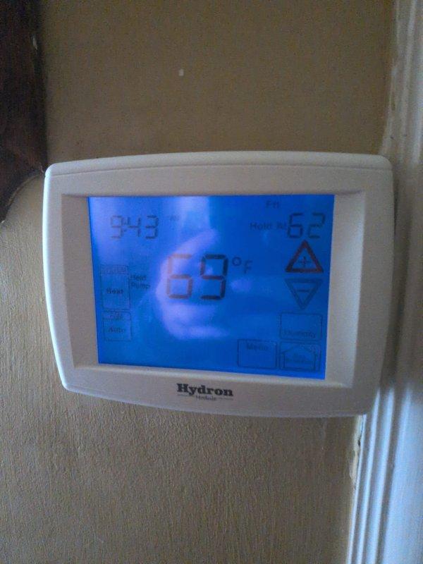Completed basic monthly heating maintenance visit on two HVAC systems. Inspected attic-mounted unit, verifying proper operation of heating components, refrigerant lines, and drainage connections. Confirmed Hydron thermostat displaying accurate temperature readings and responding properly to system calls, with unit maintaining setpoint at 69°F.