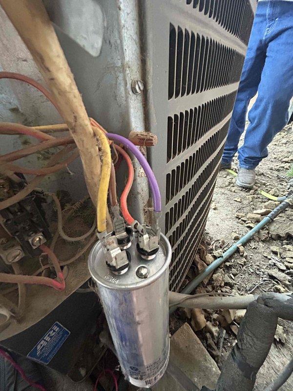 Responded to cooling system failing to maintain setpoint temperature and running continuously. Upon inspection, found aging residential air conditioning system with low refrigerant charge causing inadequate cooling performance. Verified capacitor connections and electrical components at outdoor condensing unit, inspected indoor evaporator coil and ductwork assembly. System evaluated for refrigerant loss and overall operational efficiency given age of equipment.