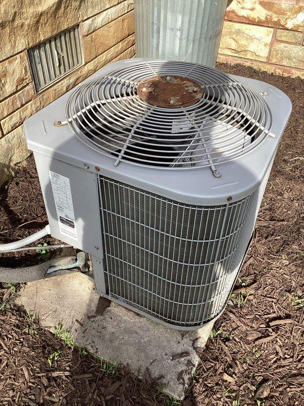 Responded to service call for air conditioning system that stopped cooling approximately two days prior with suspected compressor failure. Upon arrival, performed diagnostic evaluation of outdoor condensing unit using calibrated manifold gauges and testing equipment. Connected refrigerant gauges to service ports and measured system pressures to assess compressor operation and refrigerant charge levels. Visual inspection revealed outdoor unit with signs of age and weathering, including rust formation on fan grille assembly. Conducted comprehensive system performance analysis to determine root cause of cooling failure and verify compressor functionality.