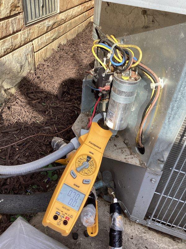 Responded to service call for air conditioning system that stopped cooling approximately two days prior with suspected compressor failure. Upon arrival, performed diagnostic evaluation of outdoor condensing unit using calibrated manifold gauges and testing equipment. Connected refrigerant gauges to service ports and measured system pressures to assess compressor operation and refrigerant charge levels. Visual inspection revealed outdoor unit with signs of age and weathering, including rust formation on fan grille assembly. Conducted comprehensive system performance analysis to determine root cause of cooling failure and verify compressor functionality.