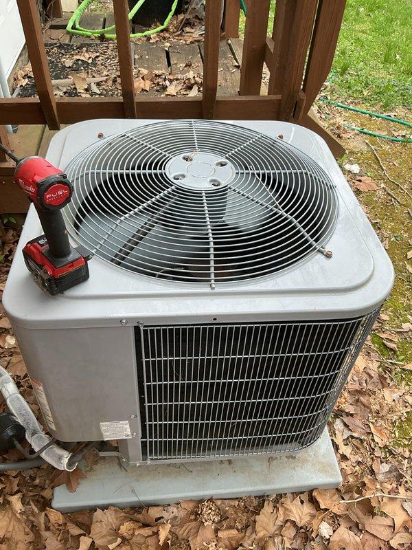 Completed Basic Monthly heating maintenance on third unit of multi-system property. Performed standard CCHP protocol inspection, verified operational status of heating system components, and documented maintenance history. System requires 20x20x4 filter replacement by customer. Photographed equipment maintenance records showing service history from Reliable Comfort Inc. and noted Fresh-Aire UV germicidal light system with lamp replacement documentation. Inspected outdoor condenser unit positioned on concrete pad adjacent to deck structure, confirming proper placement and accessibility for ongoing maintenance needs.