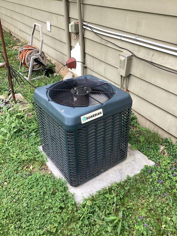 Responded to no cooling complaint on residential Guardian brand split system air conditioning unit. Upon arrival, performed visual inspection of outdoor condensing unit and indoor thermostat controls. Honeywell Home ProSeries thermostat displayed 76°F with system in off mode and fan set to auto operation, with WiFi connectivity active. Conducted diagnostic evaluation of condenser unit positioned on concrete pad, noting unit appeared operational with fan assembly visible and accessible. Verified electrical connections, refrigerant lines, and condensate drainage pathways. System components showed no obvious signs of mechanical failure or damage to housing, grille, or external connections.