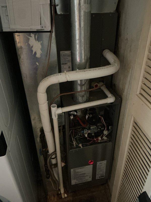 Performed routine heating maintenance on residential gas furnace system under CCHP renewal contract. Inspected internal components including burners, heat exchanger, blower motor assembly, and electrical controls with front panel removed for thorough access. Verified proper operation of condensate drain lines and PVC piping configuration. Documented filter housing location and current filter condition; noted filter size specifications for future service reference. All mechanical and electrical components found operating within normal parameters.