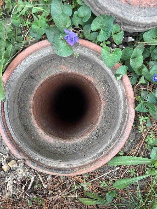 Responded to sewer line blockage affecting kitchen and powder room drainage in property with 25-year-old clay tile sewer system. Performed video camera inspection through interior floor access point and exterior cleanout to assess line condition. Camera inspection revealed significant root intrusion and confirmed deteriorated clay tile piping throughout the main sewer line, causing the obstruction and reduced flow capacity.