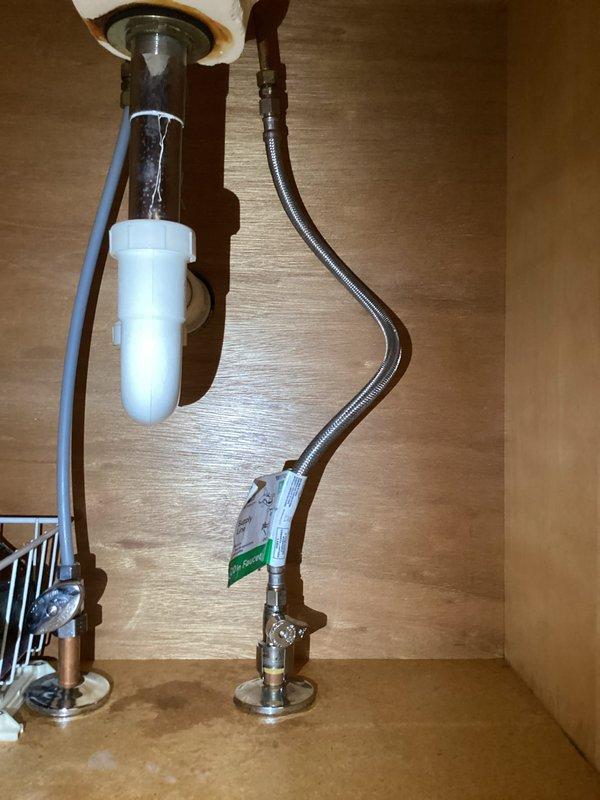 Replaced defective supply stop valve and installed new lavatory faucet assembly with chrome-finished flexible supply lines. Repaired lavatory drain connections and installed new white P-trap assembly to ensure proper drainage and prevent future leaks.