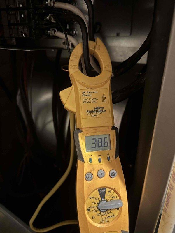 Replaced defective electric heat kit under warranty. Verified proper amperage draw of 38.6 amps on heat strips using clamp meter, confirming system is operating within manufacturer specifications and heating elements are functioning correctly.