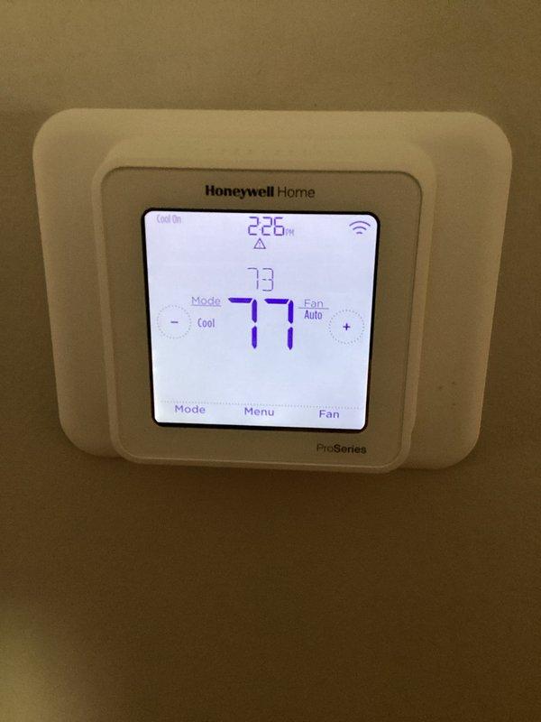 Responded to cooling complaint where system ran continuously but failed to maintain setpoint of 73°F, remaining at 78°F overnight. Inspected Honeywell Home ProSeries thermostat operation and verified proper display function showing "Cool On" mode with 73°F setpoint. Examined electrical panel components including Eaton contactor, verified proper wiring connections of control and power circuits, and confirmed all terminal connections were secure with appropriate color-coded conductors properly landed on grounding bar and control devices.