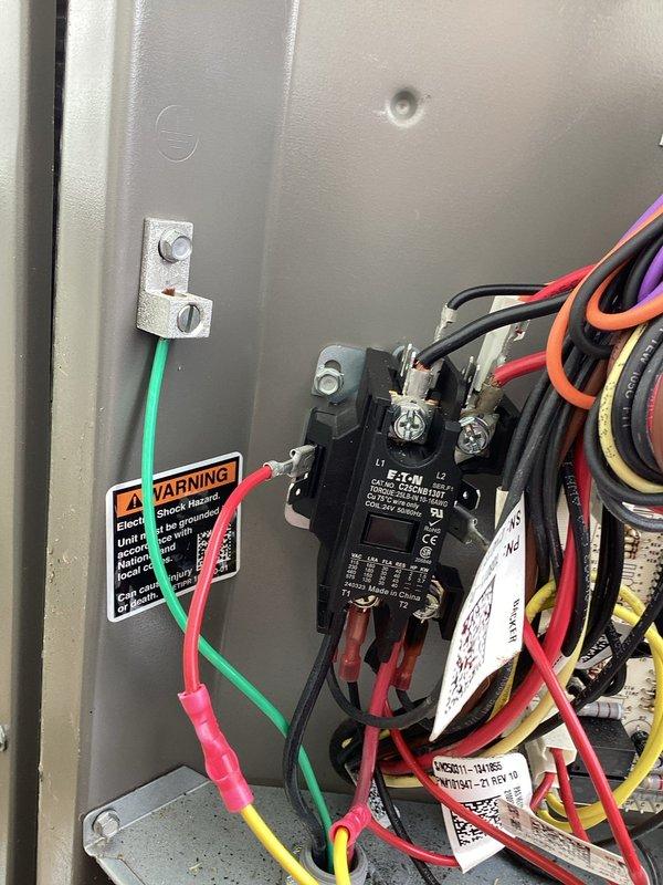 Responded to cooling complaint where system ran continuously but failed to maintain setpoint of 73°F, remaining at 78°F overnight. Inspected Honeywell Home ProSeries thermostat operation and verified proper display function showing "Cool On" mode with 73°F setpoint. Examined electrical panel components including Eaton contactor, verified proper wiring connections of control and power circuits, and confirmed all terminal connections were secure with appropriate color-coded conductors properly landed on grounding bar and control devices.