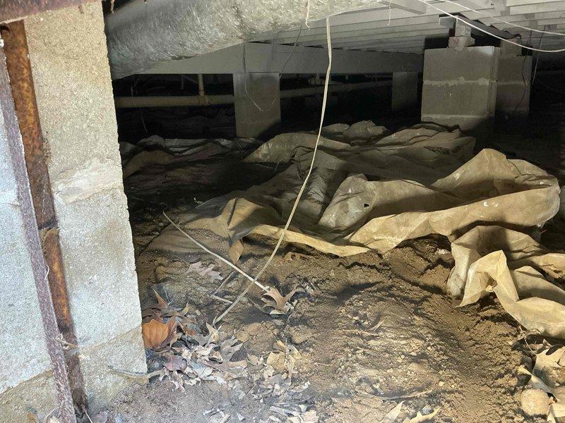 Responded to warranty call regarding improperly sloped dishwasher exhaust pipe identified during home inspection. Upon arrival, accessed crawl space and documented conditions including dishwasher drainage discharging directly into crawl space area, displaced vapor barrier material, and evidence of moisture intrusion from multiple sources. Assessed structural supports, foundation walls, and existing plumbing configuration. Photographed crawl space conditions showing compromised vapor barrier, accumulated debris, and drainage concerns. Provided proposal for corrective measures including proper exhaust pipe re-routing with appropriate slope, sump pump installation to address standing water issues, and vapor barrier repair to prevent future moisture problems.